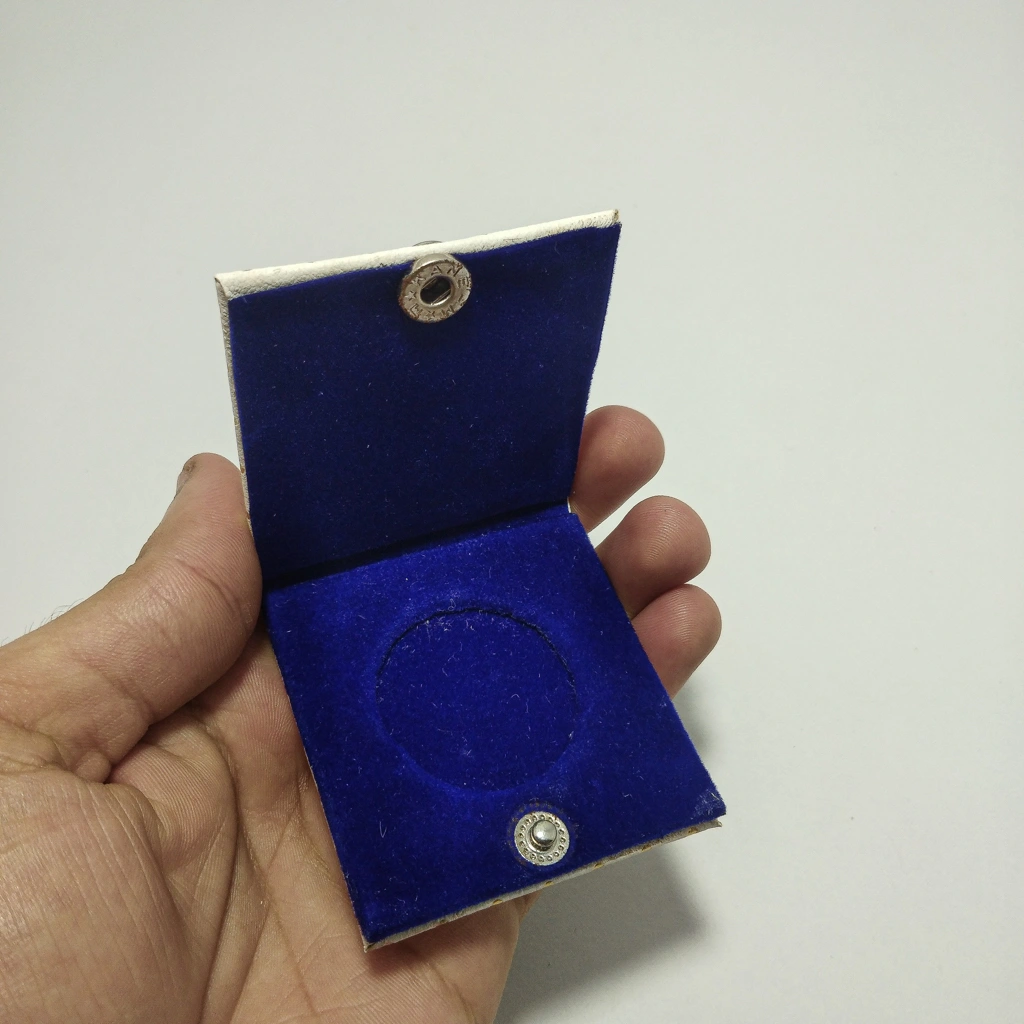white bindi button coin folder